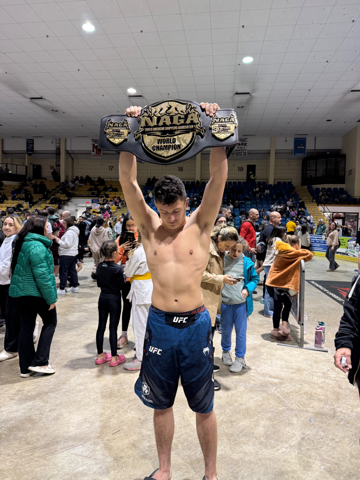 Xzavier Hicks lifting the NAGA World Champion belt overhead